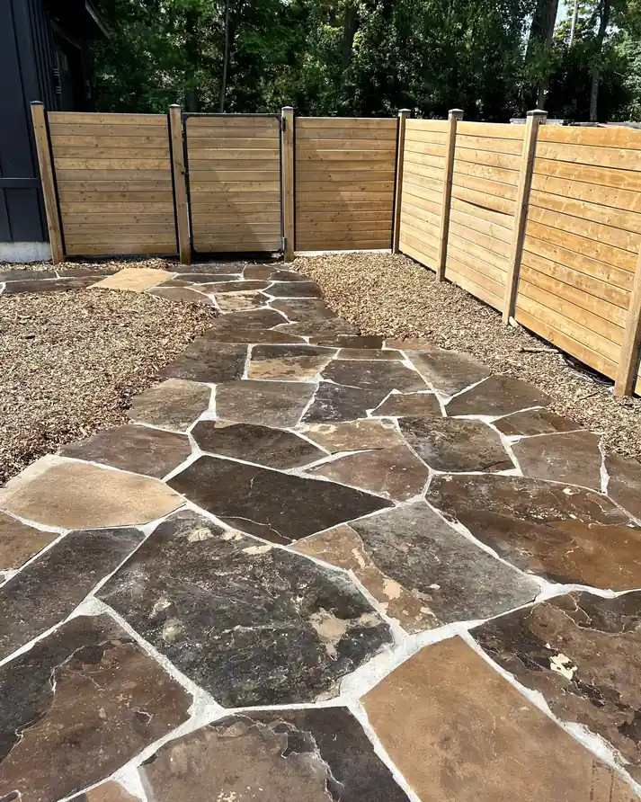 a backyard walkway designed with patio stones in lambton county. Completed by armour designs