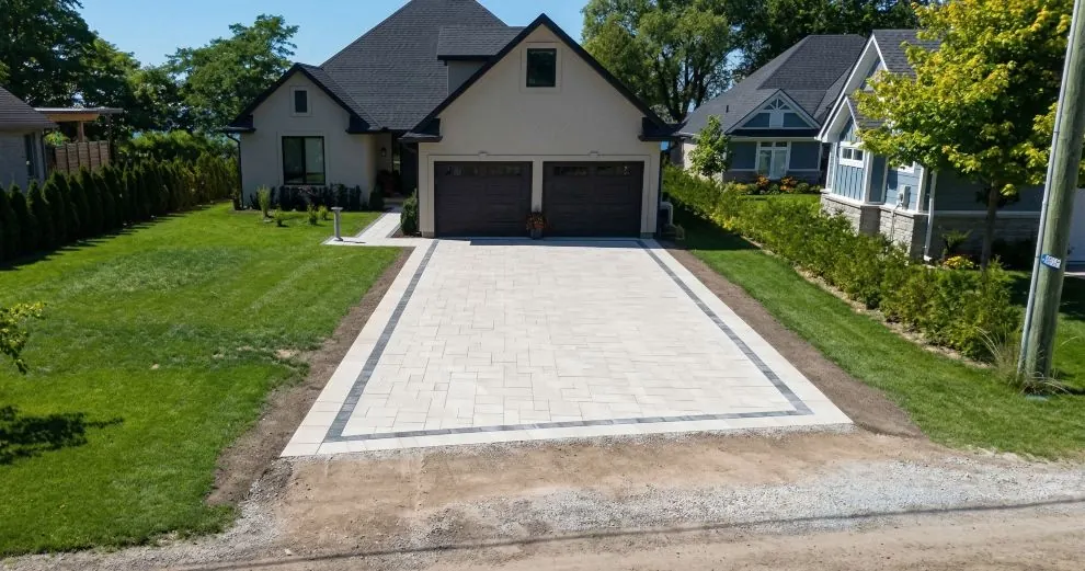 Interlocking paver driveway installation in Southwestern Ontario with clean border detailing and residential hardscaping design